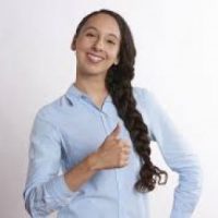 woman showing self confidence by smiling and giving a thumbs up