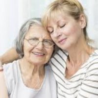 daughter holding elderly mother showing family care